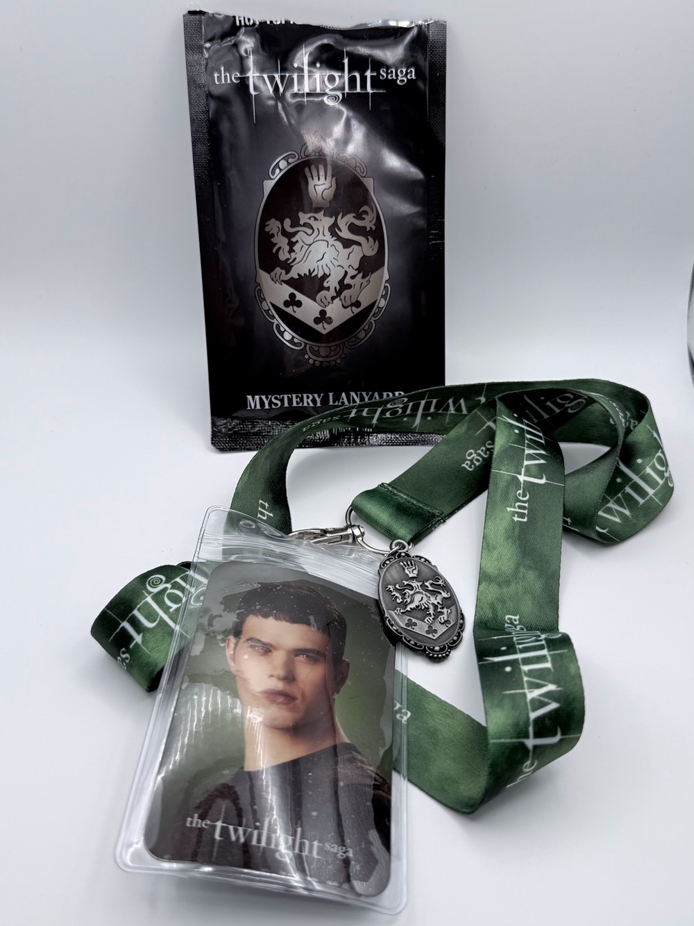 Twilight Saga mystery lanyard with green ribbon and repeating white text Emmett